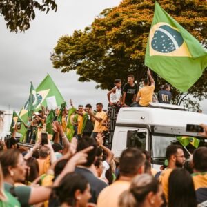 A peaceful street demonstration in Brazil with people holding national flags.