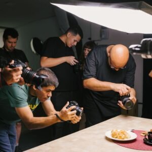 A group of photographers focusing on Brazilian dishes in a professional studio setting.