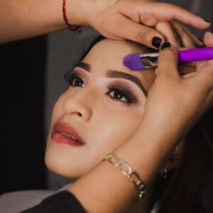 Close-up of a woman's face during a professional makeup application session.